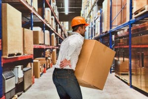 Worker feeling back pain in warehouse