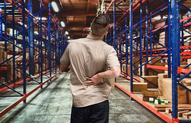 Employee having back pain in warehouse
