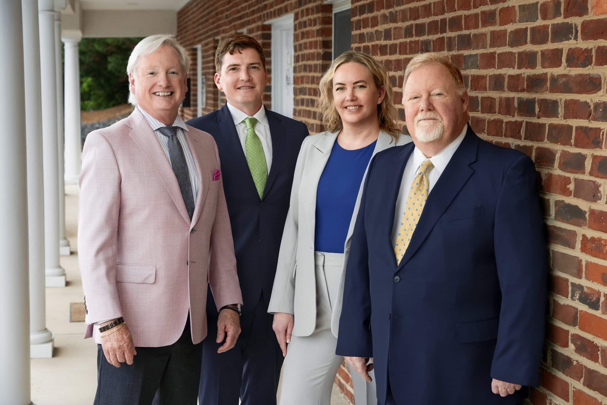 HammondTownsend 4 lawyers standing by brick wall George Townsend, Wyck Sweeney, Elyse Stiner, Steve Hammond