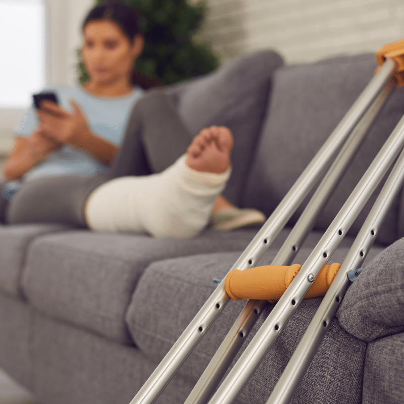 HT - Woman with cast lays on couch